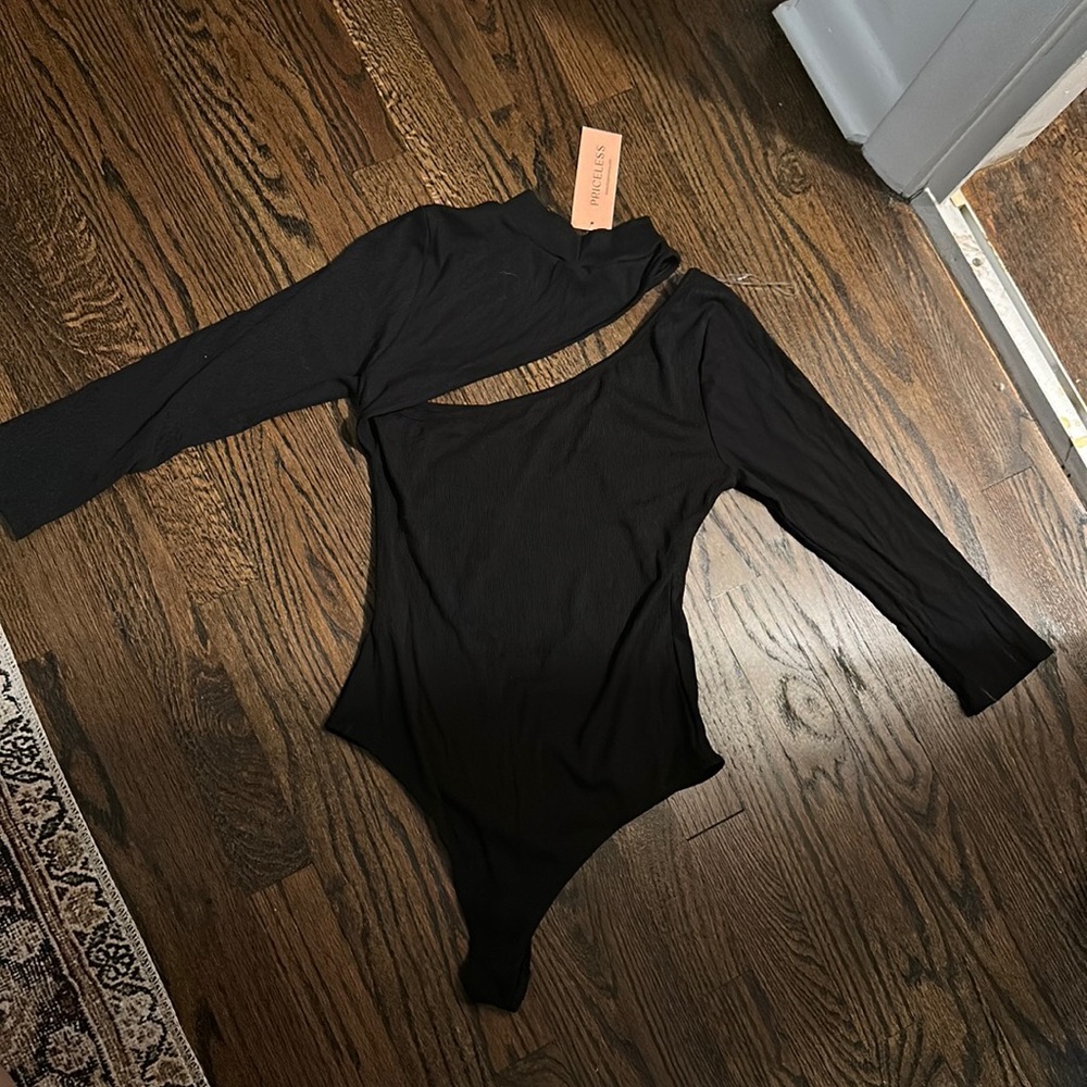 Black, long sleeve bodysuit. NWT. Unique neck/chest line cut outs.